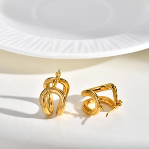 Minimalist double-layered gold U-shape hoop earrings with a brushed metal texture