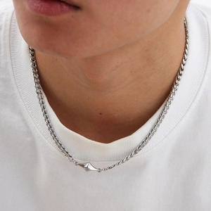 Male model wearing silver stainless steel Cuban chain necklace with diamond pendant