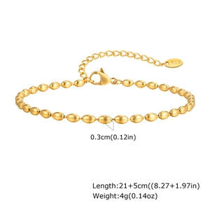 Macro detail of 18K gold bead anklet with lobster clasp and K18 hallmark tag