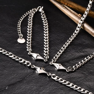 Mens minimalist silver cuban chain jewelry set with inlaid stones on stone background