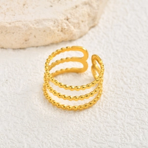 Close-up of golden three-layer open ring with beaded texture and adjustable band