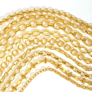 Various high-quality golden stainless steel chains with diverse link designs in a group
