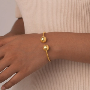 Bracciale aperto in acciaio inossidabile dorato lucido con eleganti doppie sfere da donna