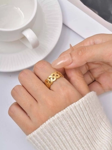 Detail shot of a wide gold triple-layered woven snake ring with a vintage matte finish