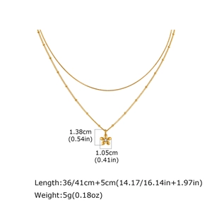 Detail of gold double-layer snake chain with flower pendant and length measurements