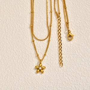 Double-layered gold stainless steel necklace with snake chain and zircon flower pendant