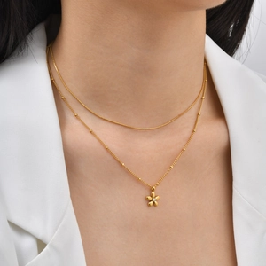 Double-layered gold snake and satellite chain necklace with crystal flower pendant