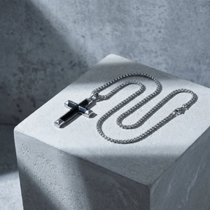 Stainless steel cross pendant necklace with black onyx inlay on industrial stone block