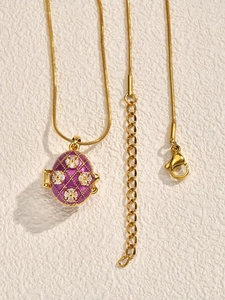 Detail of vintage red and white Easter egg locket pendant on fine gold chain