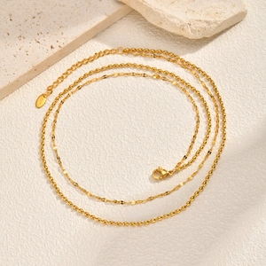 Double-layered gold stainless steel necklace with round beads and flat chain detail
