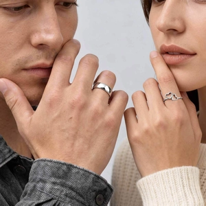 Polished stainless steel couple rings featuring a men's band and women's double heart design