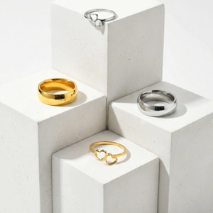 Minimalist polished stainless steel rings in gold and silver with hollow heart design