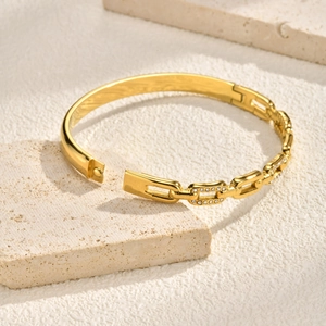 Detailed macro view of gold-plated stainless steel chain bracelet with zircon pavé accents