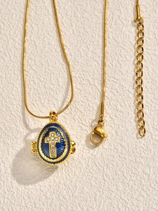 Detail of blue enamel Easter egg pendant with gold cross and lobster clasp chain