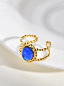 Detail of vintage double-layered gold bead ring featuring a large blue oval stone inlay