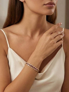 Close-up of luxury red and white baguette-cut zircon tennis bracelet on wrist