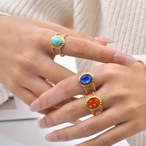 Retro geometric double-layered gold rings with vibrant faux gemstones on a model