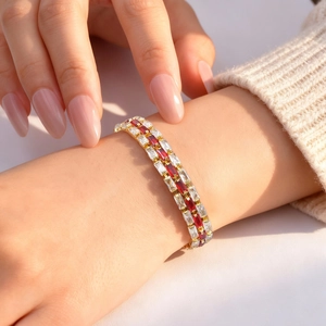 Three-row gold bracelet with red and white rectangular zircon stones on model wrist