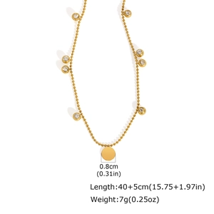 Detail of gold ball chain necklace with zircon charms and 0.8cm round pendant