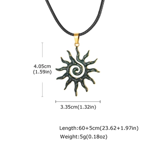 Detail showing dimensions of a sun spiral pendant with green enamel and leather cord
