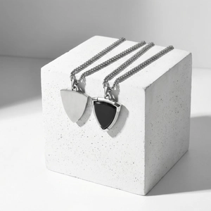 Modern stainless steel necklace featuring black onyx shield pendant and curb chain