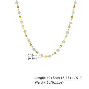 Detail of beaded sugar cube necklace showing light blue spacers and golden bead texture