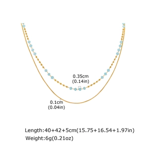 Detail view of double-layer gold chain necklace with light blue beads and size annotations
