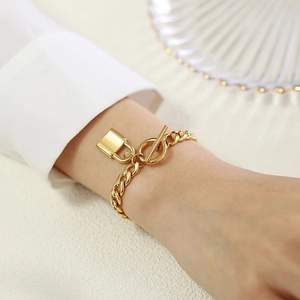 Gold stainless steel 7mm Cuban chain bracelet with lock charm and toggle clasp for women