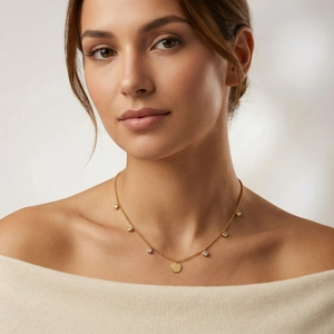 Close-up of 18K gold stainless steel necklace with round pendant and zircon stones
