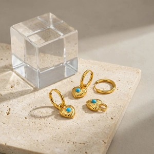 French vintage heart lock earrings in gold with turquoise stone on stone background