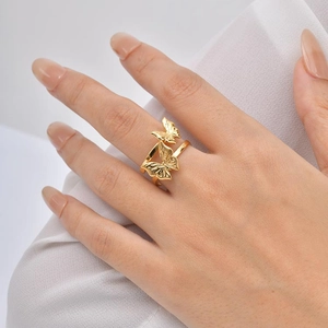 Detail shot of golden butterfly ring showing intricate bionic texture and dual wing design