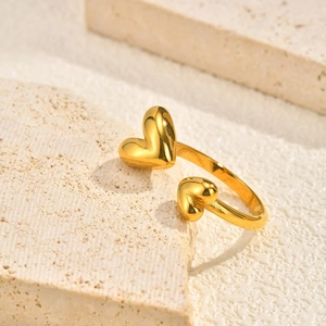 Macro shot of gold double heart open ring on elegant textured stone background