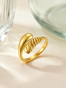 Detailed macro shot of a gold-plated multi-layer teardrop ring with textured spiral finish