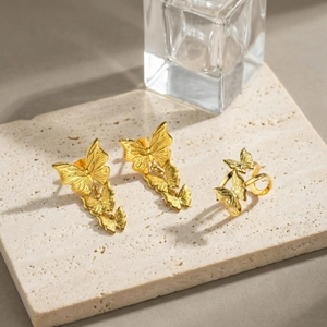 Golden stainless steel butterfly jewelry set including drop earrings and open ring on stone