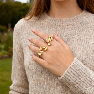 Elegant gold butterfly and heart open ring set for women on model with garden background