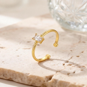 Detailed view of an 18K gold plated ring with a rectangular zircon on stone