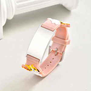 Macro view of pink silicone kids ID bracelet with polished metal plate and tiger detail
