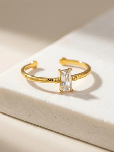 Detailed macro view of the gold-plated hammered band ring with a square-cut zircon stone