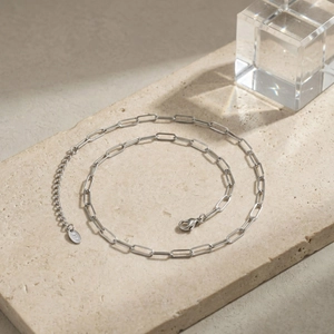 Detail of stainless steel paperclip chain with lobster clasp and K18 hallmark tag