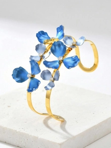 Detail of double-layer gold bangle with blue enamel flowers and zircon centers