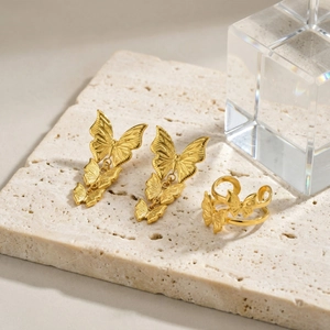 Golden stainless steel butterfly jewelry set featuring drop earrings and open ring