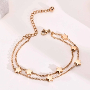 Detail of rose gold double-layer bracelet with star charms and adjustable lobster clasp
