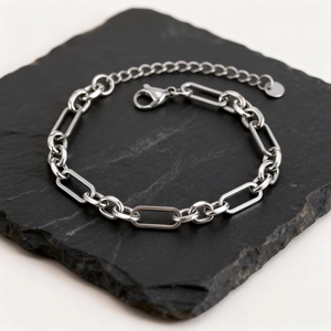 Minimalist silver stainless steel link chain bracelet for men on black stone base