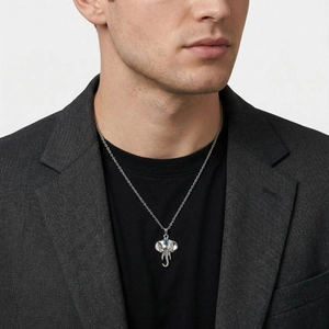 Detail of silver elephant pendant with blue gemstone on a trendy stainless steel necklace