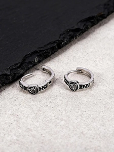 Detailed view of Valknut symbols and Runic characters on silver Viking hoop earrings