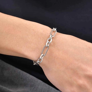 Close-up of minimalist stainless steel paperclip chain bracelet on a male wrist