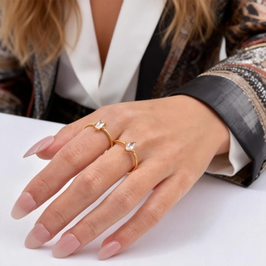 Gold open rings with marquise and rectangular cubic zirconia on a model hand