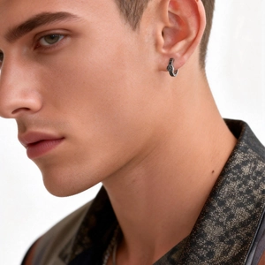 Close-up of men's punk stainless steel hoop earring with engraved Viking Valknut symbol