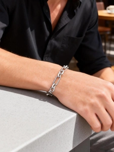 Close-up of industrial style stainless steel chain bracelet on a male wrist