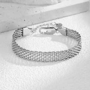 Macro detail of silver mesh bracelet with four-row weave and secure lobster clasp